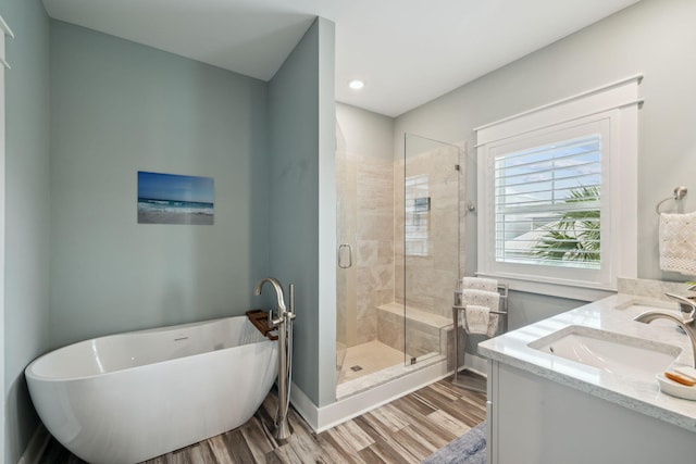 38 Constant Ave, Santa Rosa Beach, FL 32459 - full bathroom with wood finished floors, a freestanding tub, a stall shower, and vanity