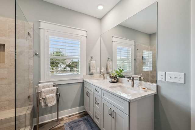 38 Constant Ave, Santa Rosa Beach, FL 32459 - full bath with double vanity, a walk in shower, and wood finished floors