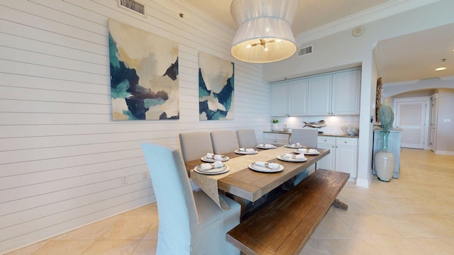 11807 Front Beach Rd Unit 1- 2204, Panama City Beach, FL 32407 - dining room with ornamental molding, arched walkways, light tile patterned flooring, and wooden walls