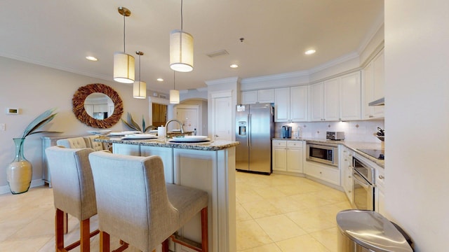 11807 Front Beach Rd Unit 1- 2204, Panama City Beach, FL 32407 - kitchen with appliances with stainless steel finishes, light tile patterned flooring, ornamental molding, under cabinet range hood, and arched walkways