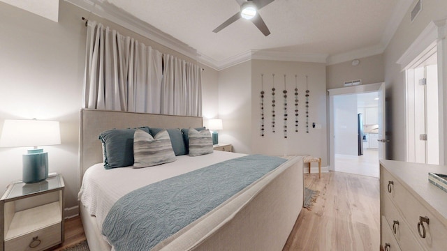 11807 Front Beach Rd Unit 1- 2204, Panama City Beach, FL 32407 - bedroom with ornamental molding, light wood-style floors, a ceiling fan, and baseboards