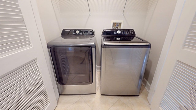 11807 Front Beach Rd Unit 1- 2204, Panama City Beach, FL 32407 - washroom featuring washer and dryer and light tile patterned floors