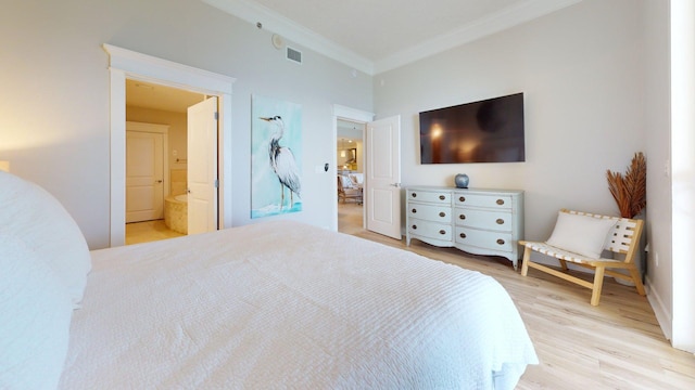 11807 Front Beach Rd Unit 1- 2204, Panama City Beach, FL 32407 - bedroom with ornamental molding, light wood-type flooring, and ensuite bathroom