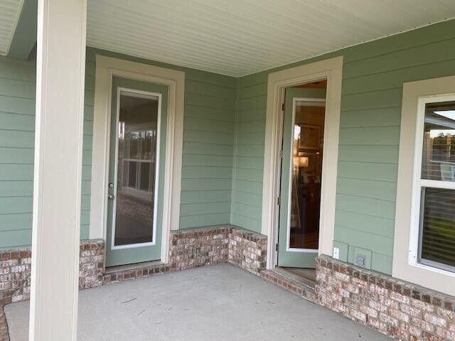115 S Speckled Trout Ln Lot 262, Freeport, FL 32439 - view of exterior entry with a porch
