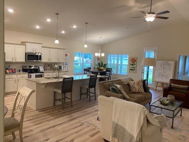 115 S Speckled Trout Ln Lot 262, Freeport, FL 32439 - living room featuring light wood-type flooring, ceiling fan, recessed lighting, a chandelier, and high vaulted ceiling