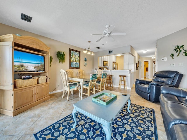 85 S Driftwood Bay Unit 227, Miramar Beach, FL 32550 - living room featuring a ceiling fan, a textured ceiling, light tile patterned floors, and baseboards
