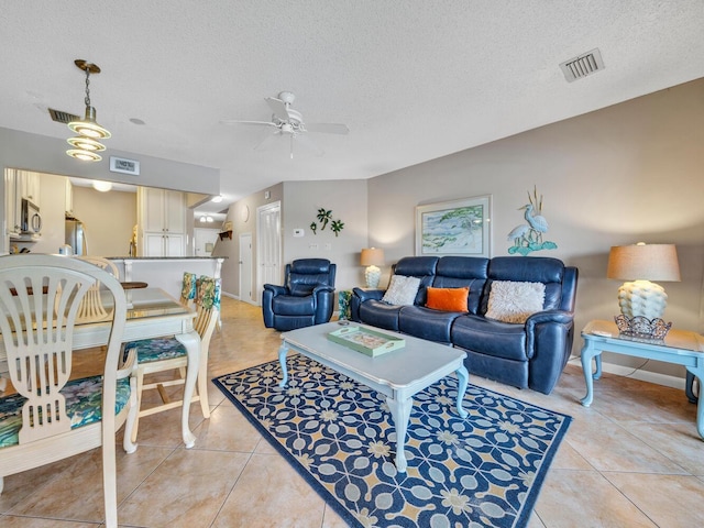 85 S Driftwood Bay Unit 227, Miramar Beach, FL 32550 - living room featuring light tile patterned floors, a textured ceiling, and a ceiling fan