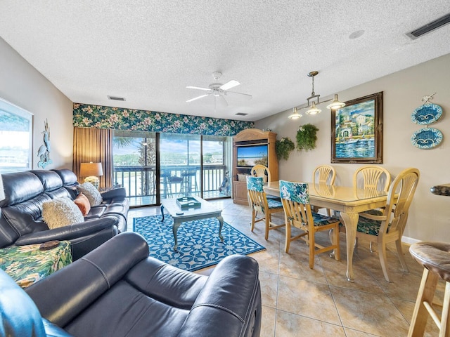 85 S Driftwood Bay Unit 227, Miramar Beach, FL 32550 - living area with ceiling fan, a textured ceiling, light tile patterned floors, and baseboards