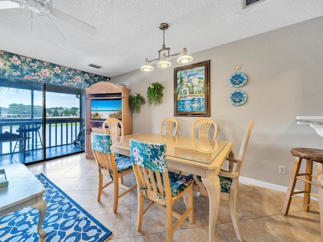 85 S Driftwood Bay Unit 227, Miramar Beach, FL 32550 - dining area with a ceiling fan, a textured ceiling, and light tile patterned flooring