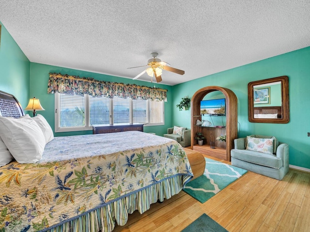 85 S Driftwood Bay Unit 227, Miramar Beach, FL 32550 - bedroom featuring wood finished floors, a textured ceiling, a ceiling fan, and baseboards