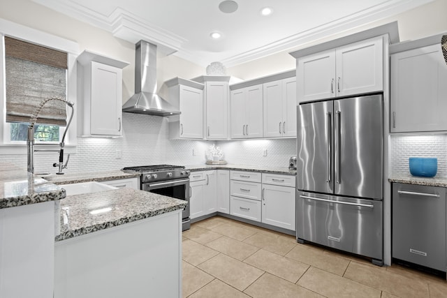 14 The Heron Cv, Inlet Beach, FL 32461 - kitchen featuring high end appliances, wall chimney exhaust hood, decorative backsplash, light stone counters, and light tile patterned flooring
