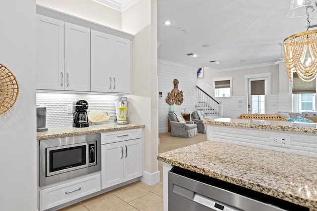 14 The Heron Cv, Inlet Beach, FL 32461 - kitchen with stainless steel appliances, open floor plan, ornamental molding, healthy amount of natural light, and light tile patterned floors
