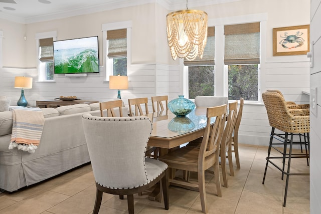 14 The Heron Cv, Inlet Beach, FL 32461 - dining area featuring a chandelier, light tile patterned floors, crown molding, and wainscoting
