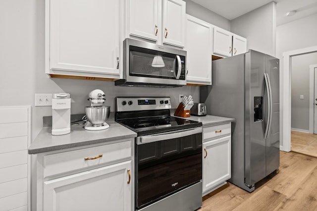 319 Key Lime Pl, Crestview, FL 32536 - kitchen with appliances with stainless steel finishes, white cabinets, light wood-type flooring, and light countertops