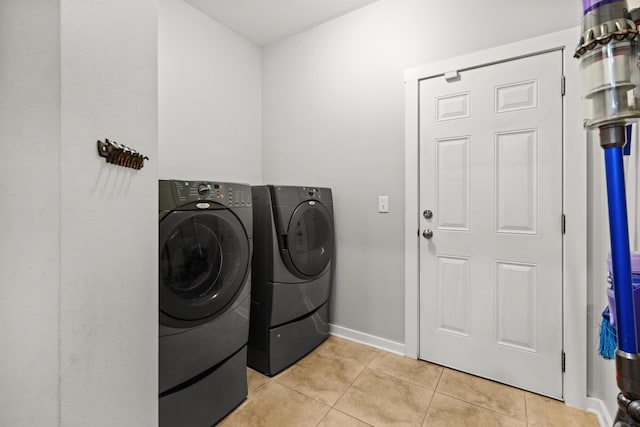 319 Key Lime Pl, Crestview, FL 32536 - laundry room featuring washer and clothes dryer, light tile patterned floors, and baseboards