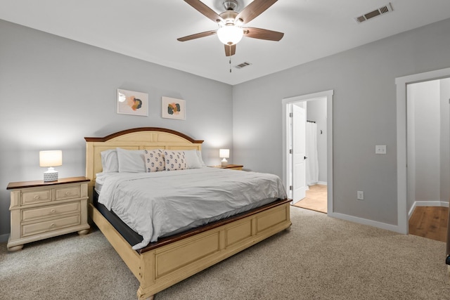 319 Key Lime Pl, Crestview, FL 32536 - bedroom featuring light carpet, baseboards, a ceiling fan, and ensuite bath