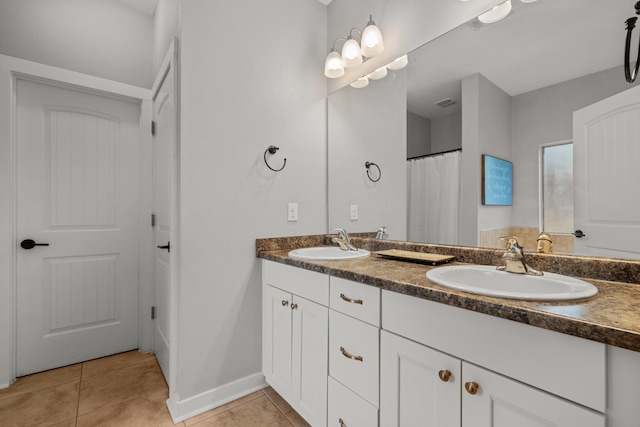 319 Key Lime Pl, Crestview, FL 32536 - bathroom with double vanity, tile patterned flooring, and baseboards