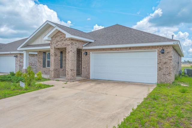 4652 Honor Guard Way, Crestview, FL 32539 - ranch-style house featuring brick siding, concrete driveway, an attached garage, and a shingled roof