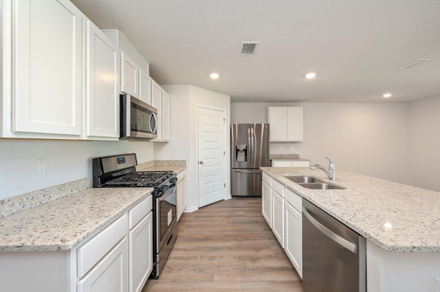 4652 Honor Guard Way, Crestview, FL 32539 - kitchen featuring stainless steel appliances, light wood-style flooring, white cabinets, and recessed lighting