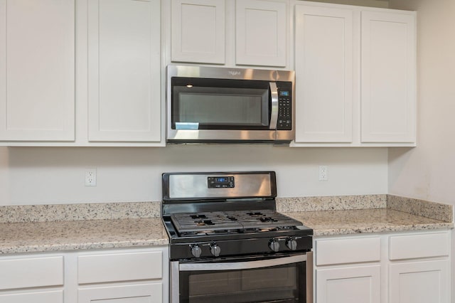 4652 Honor Guard Way, Crestview, FL 32539 - kitchen featuring stainless steel appliances, white cabinetry, and light stone countertops