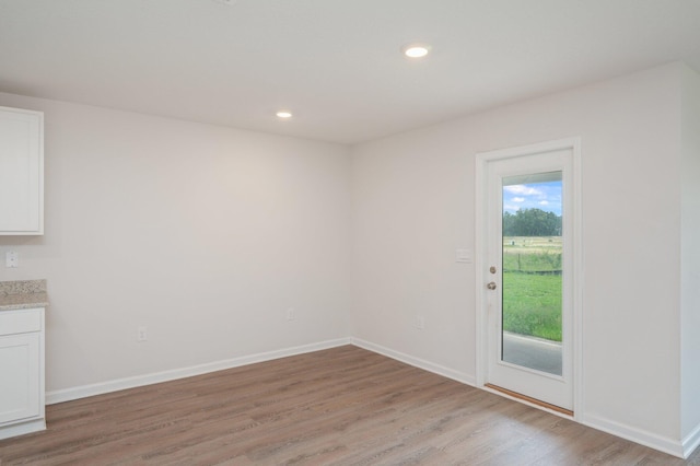 4652 Honor Guard Way, Crestview, FL 32539 - unfurnished dining area with light wood finished floors and recessed lighting