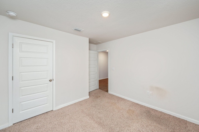 4652 Honor Guard Way, Crestview, FL 32539 - unfurnished bedroom with carpet flooring and a textured ceiling