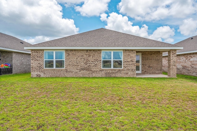 4652 Honor Guard Way, Crestview, FL 32539 - back of property with a patio area, brick siding, and a lawn
