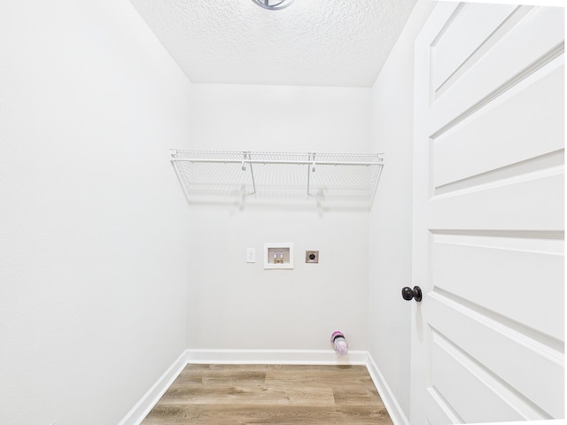 5117 Colt Dr, Crestview, FL 32539 - laundry room with electric dryer hookup, hookup for a washing machine, light wood-style floors, and a textured ceiling