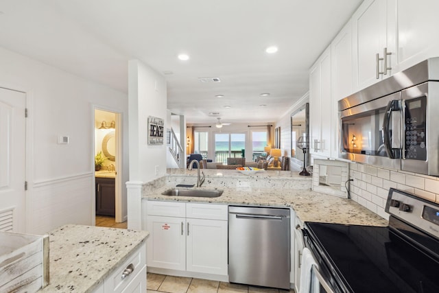 23011 Front Beach Rd Unit E-20, Panama City Beach, FL 32413 - kitchen with appliances with stainless steel finishes, a sink, light stone countertops, white cabinetry, and recessed lighting