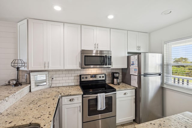 23011 Front Beach Rd Unit E-20, Panama City Beach, FL 32413 - kitchen with appliances with stainless steel finishes, tasteful backsplash, white cabinetry, light stone counters, and recessed lighting