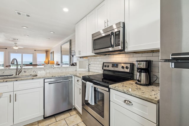 23011 Front Beach Rd Unit E-20, Panama City Beach, FL 32413 - kitchen with stainless steel appliances, a sink, ceiling fan, white cabinets, and recessed lighting