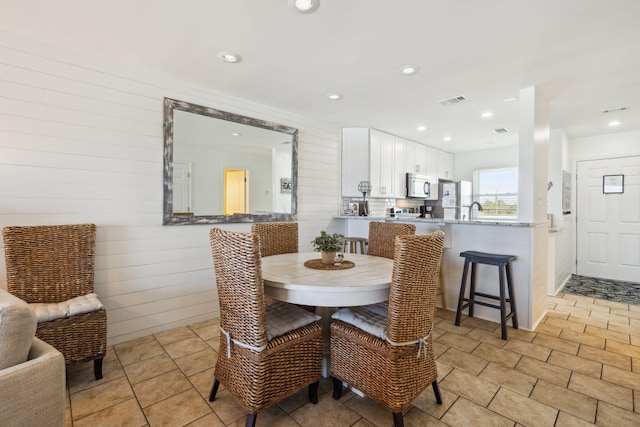 23011 Front Beach Rd Unit E-20, Panama City Beach, FL 32413 - dining room with wood walls and recessed lighting