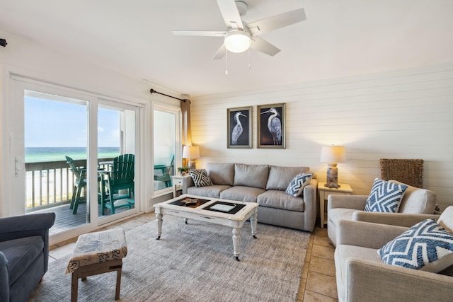 23011 Front Beach Rd Unit E-20, Panama City Beach, FL 32413 - living area featuring light tile patterned floors, a ceiling fan, and a water view