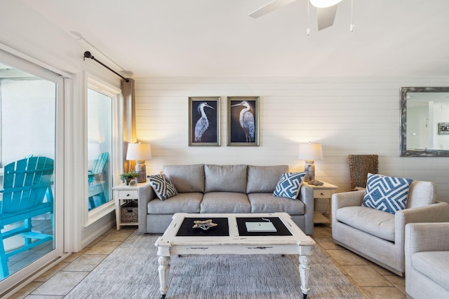 23011 Front Beach Rd Unit E-20, Panama City Beach, FL 32413 - living area featuring plenty of natural light, light tile patterned flooring, a ceiling fan, and wood walls
