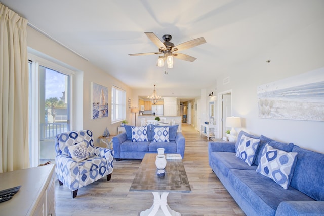 112 Seascape Blvd Unit 210, Miramar Beach, FL 32550 - living room with light wood-type flooring, a chandelier, and a ceiling fan