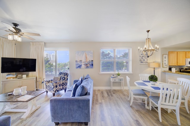 112 Seascape Blvd Unit 210, Miramar Beach, FL 32550 - living room with a chandelier, light wood-style flooring, and a ceiling fan