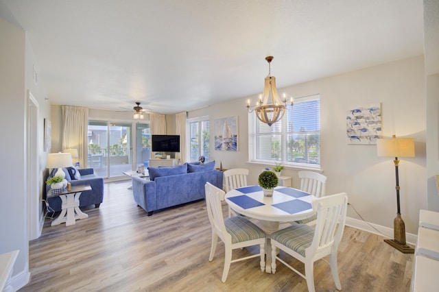 112 Seascape Blvd Unit 210, Miramar Beach, FL 32550 - dining room with light wood-style floors, a chandelier, and ceiling fan