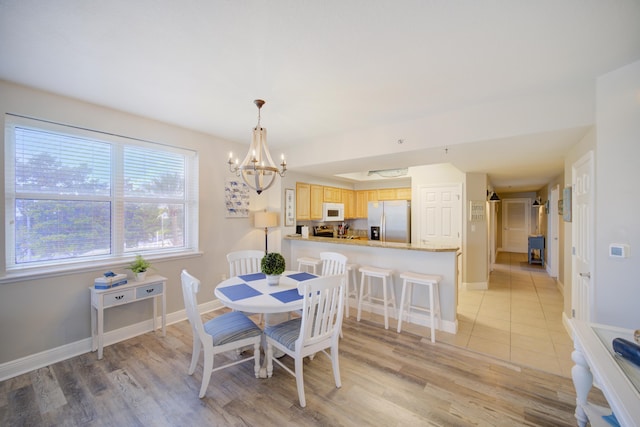 112 Seascape Blvd Unit 210, Miramar Beach, FL 32550 - dining area with a chandelier and light wood-type flooring