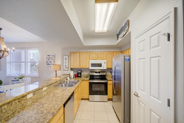 112 Seascape Blvd Unit 210, Miramar Beach, FL 32550 - kitchen with appliances with stainless steel finishes, light brown cabinetry, light tile patterned flooring, and a chandelier