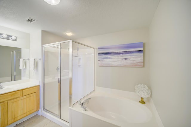 112 Seascape Blvd Unit 210, Miramar Beach, FL 32550 - bathroom with a bath, vanity, a stall shower, a textured ceiling, and tile patterned flooring