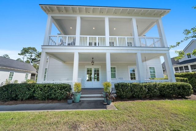 339 Pathways Dr, Inlet Beach, FL 32461 - view of front of property with covered porch, a balcony, and a front lawn