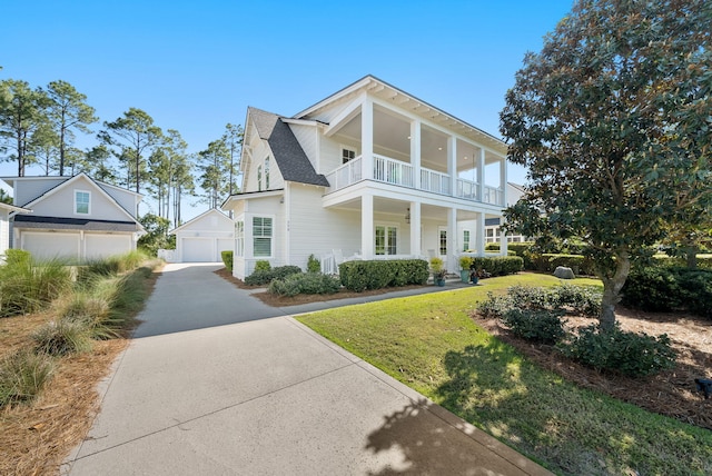 339 Pathways Dr, Inlet Beach, FL 32461 - view of front of house with a balcony, an outbuilding, a front yard, and a detached garage