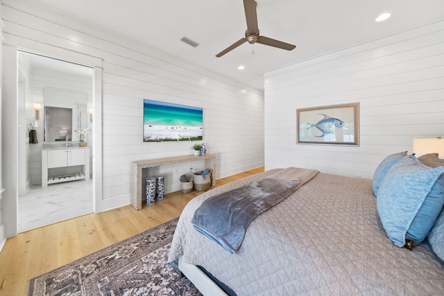 339 Pathways Dr, Inlet Beach, FL 32461 - bedroom with wooden walls, wood finished floors, recessed lighting, a ceiling fan, and connected bathroom