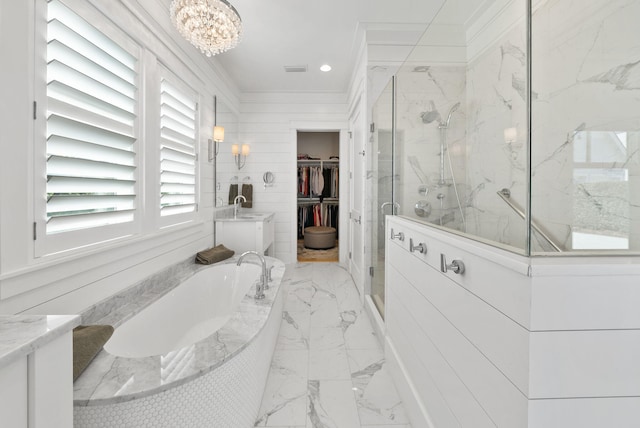339 Pathways Dr, Inlet Beach, FL 32461 - full bath with marble tiled floors, a marble finish shower, a garden tub, a walk in closet, and a chandelier
