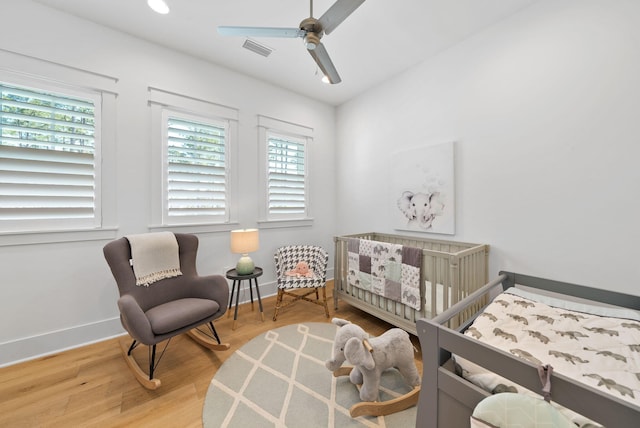 339 Pathways Dr, Inlet Beach, FL 32461 - bedroom with baseboards, a nursery area, a ceiling fan, and wood finished floors