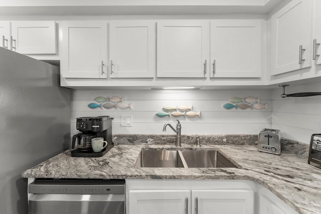 23223 Front Beach Rd # 335, Panama City Beach, FL 32413 - kitchen featuring stainless steel appliances, white cabinetry, a sink, and light stone counters