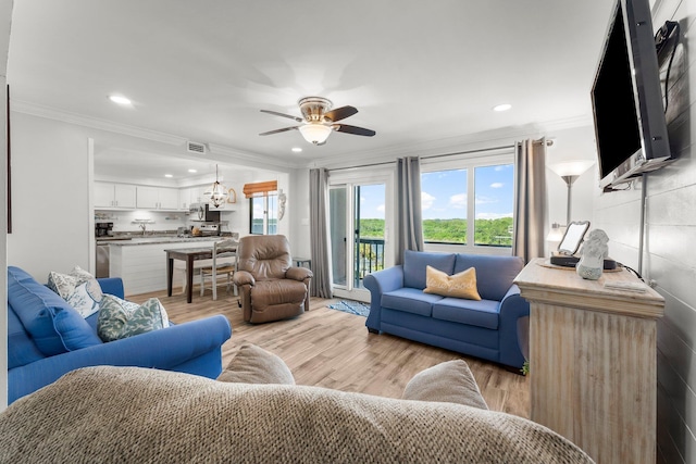 23223 Front Beach Rd # 335, Panama City Beach, FL 32413 - living area featuring recessed lighting, crown molding, a ceiling fan, light wood-style floors, and a chandelier