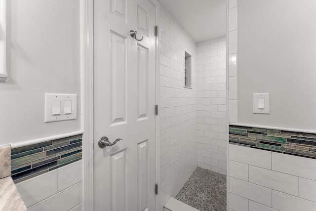 23223 Front Beach Rd # 335, Panama City Beach, FL 32413 - full bathroom featuring tile walls, wainscoting, and a tile shower