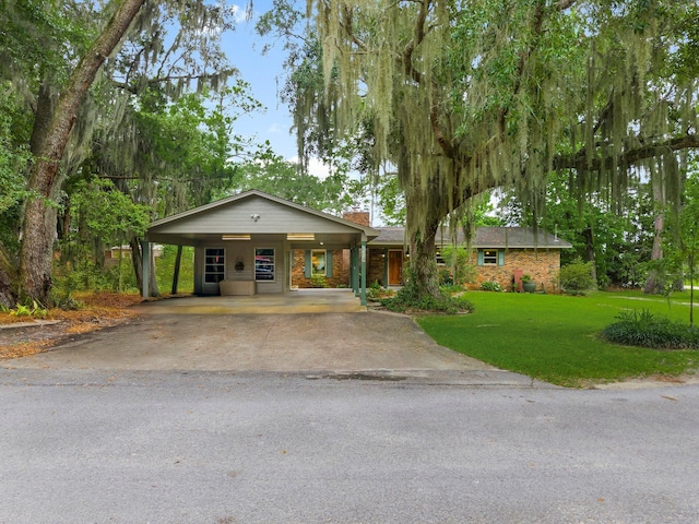 619 Pitts Bayshore Dr, Freeport, FL 32439 - single story home featuring a chimney, a front yard, asphalt driveway, and a carport