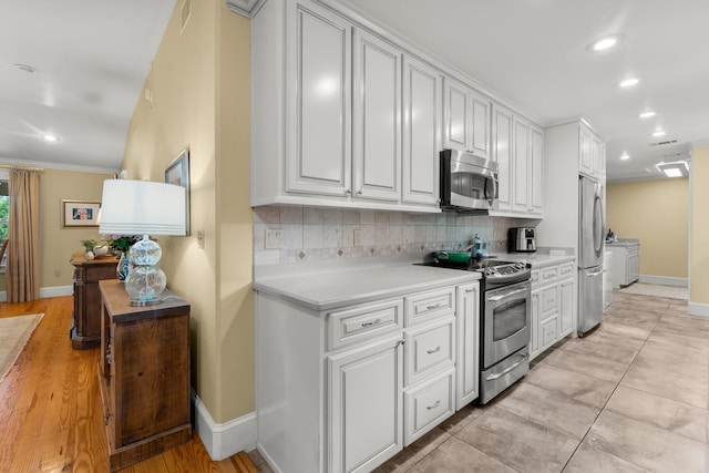 619 Pitts Bayshore Dr, Freeport, FL 32439 - kitchen featuring stainless steel appliances, recessed lighting, light countertops, tasteful backsplash, and white cabinets
